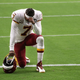 Quarterback Dwayne Haskins #7 of the Washington Football Team kneels on the field before the NFL game against the Arizona Cardinals at State Farm Stadium on September 20, 2020, in Glendale, Arizona.